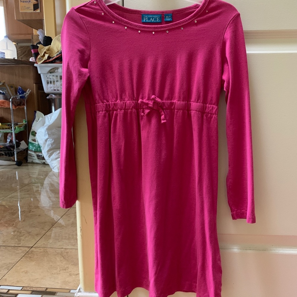 Pink dress with a small bow and some gems